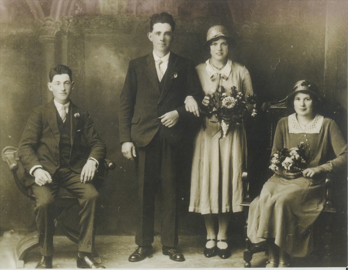 A wedding photograph from the 1930s. My father's parents on their wedding day, posed in a photographer's studio with another couple, the bride holding a bouquet.