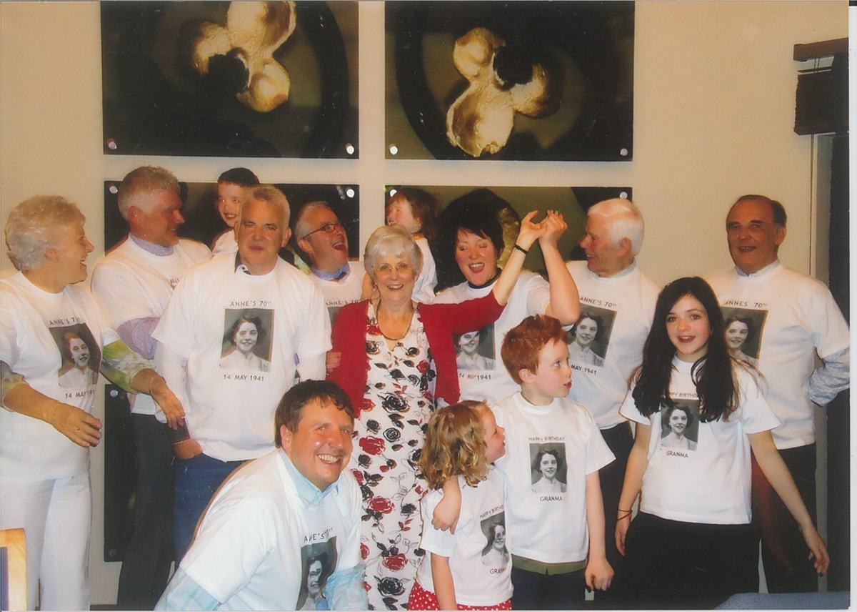 A large family gathering for my mother Anne's seventieth birthday. Every person is wearing a printed t-shirt showing the portrait photograph taken of her in 1941.